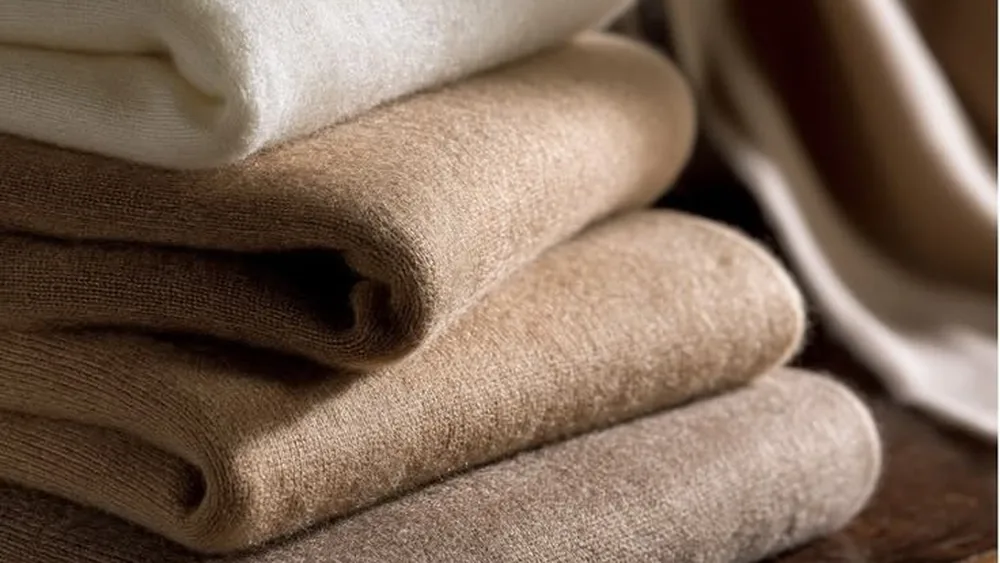 Folded knitwear showing fabric weight and texture